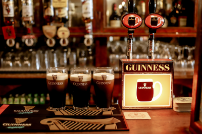 three pints of guinness on a bar 